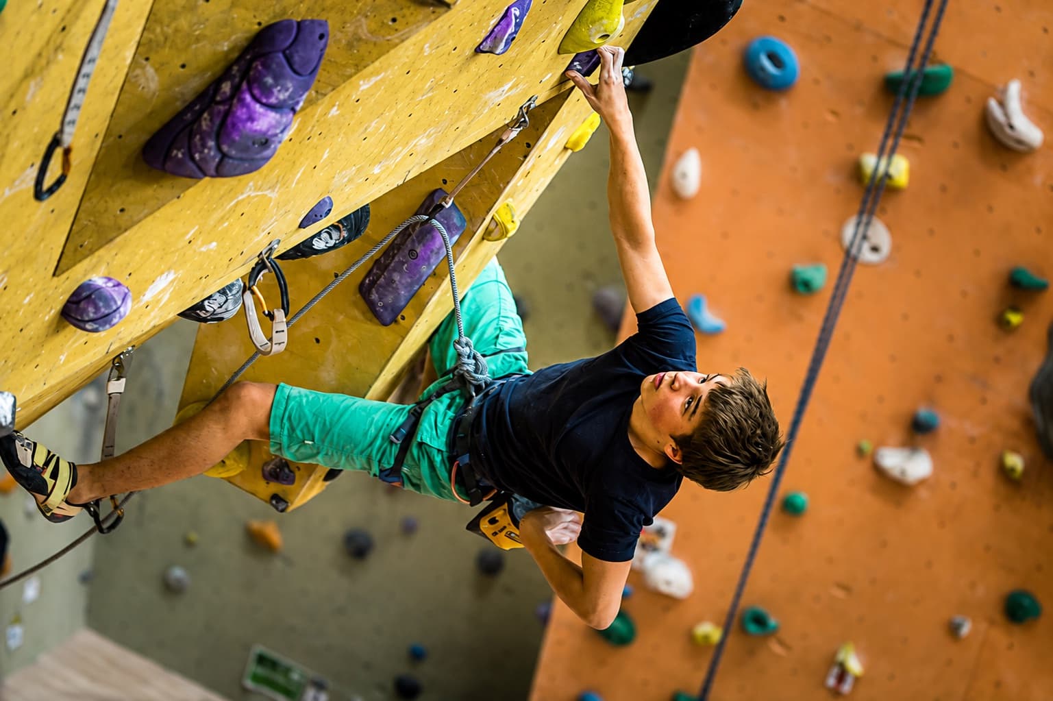 Competing on a purple and yellow lead wall