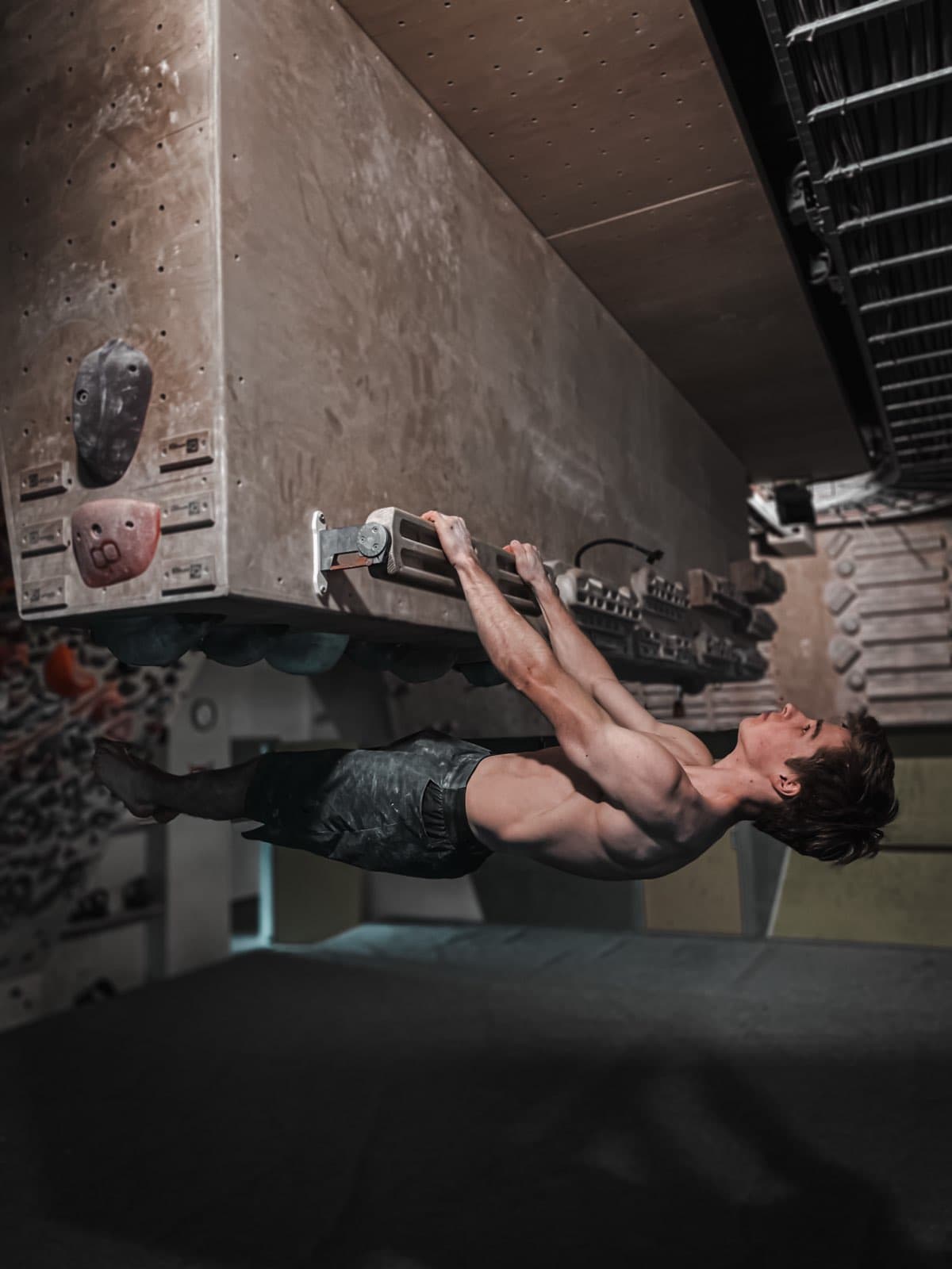 Holding a front lever from a training rung under a plywood board