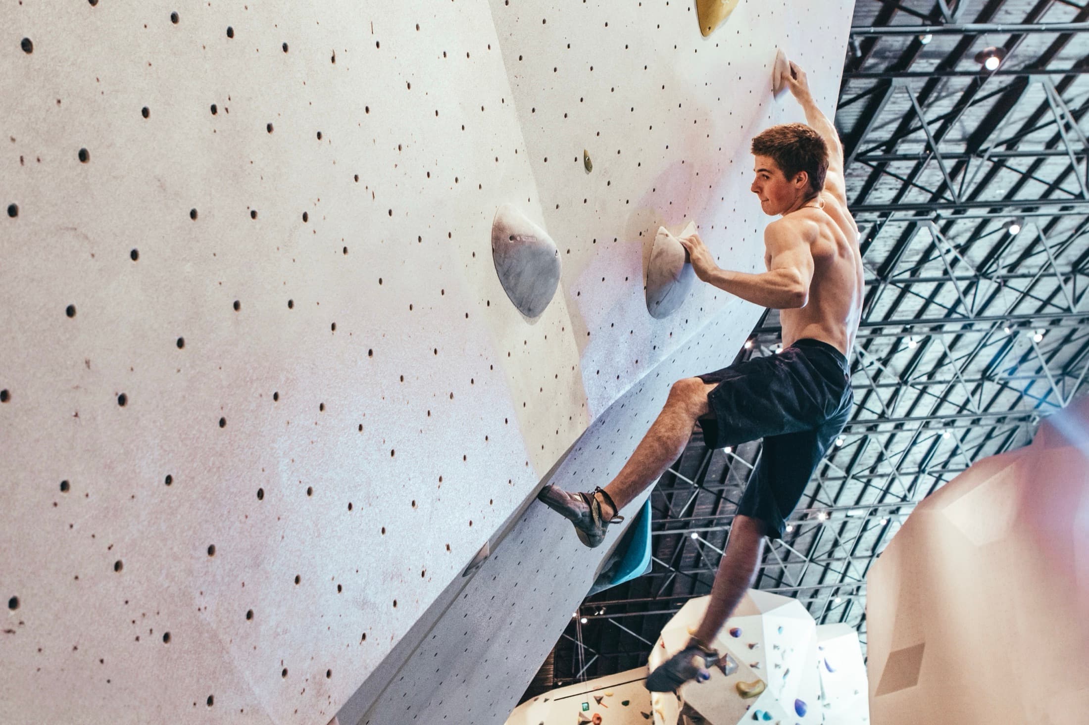 Bouldering at sunrise on a colourful indoor wall