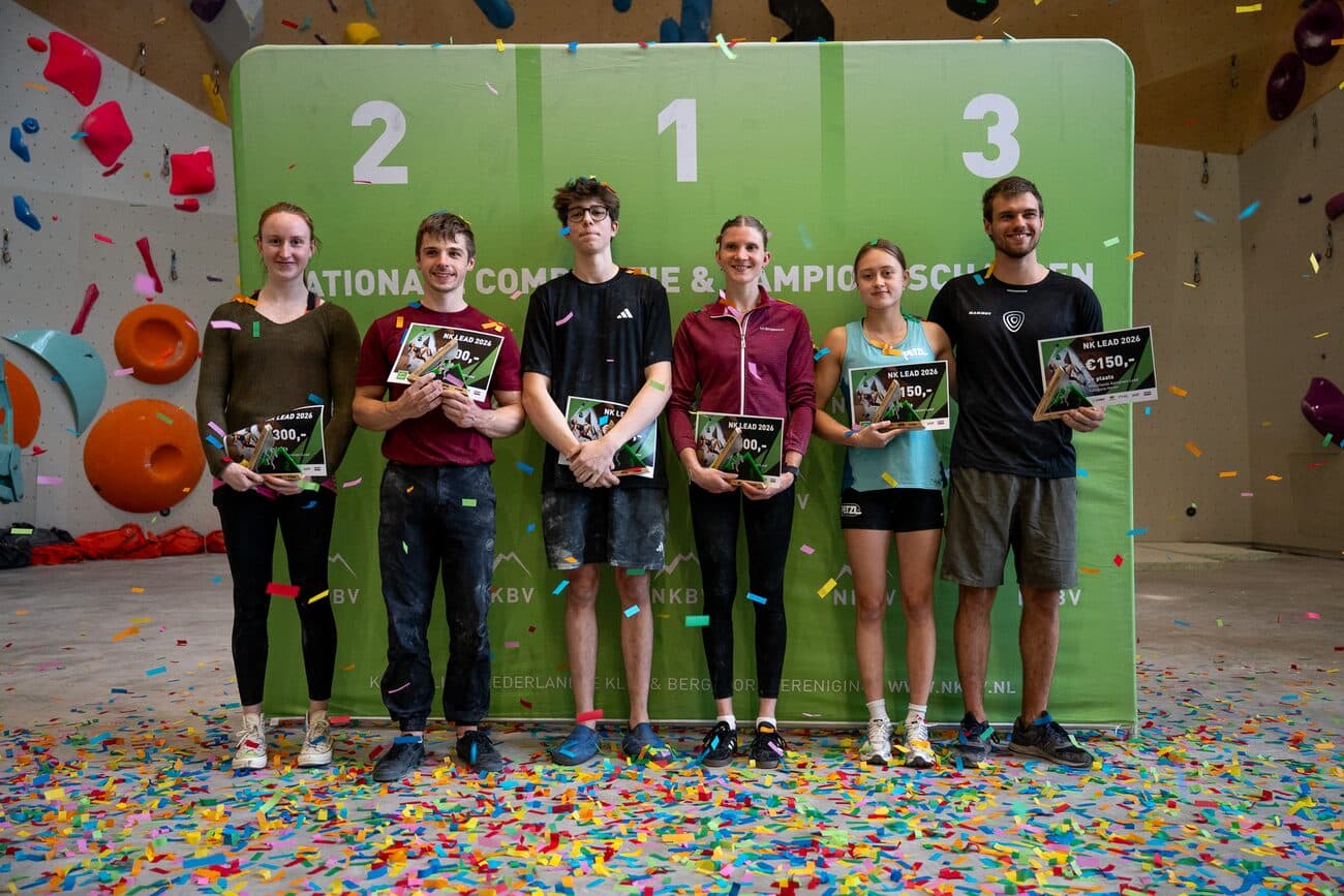 The podium at the Dutch National Lead Championship 2026, six athletes on the 1-2-3 board with confetti on the floor